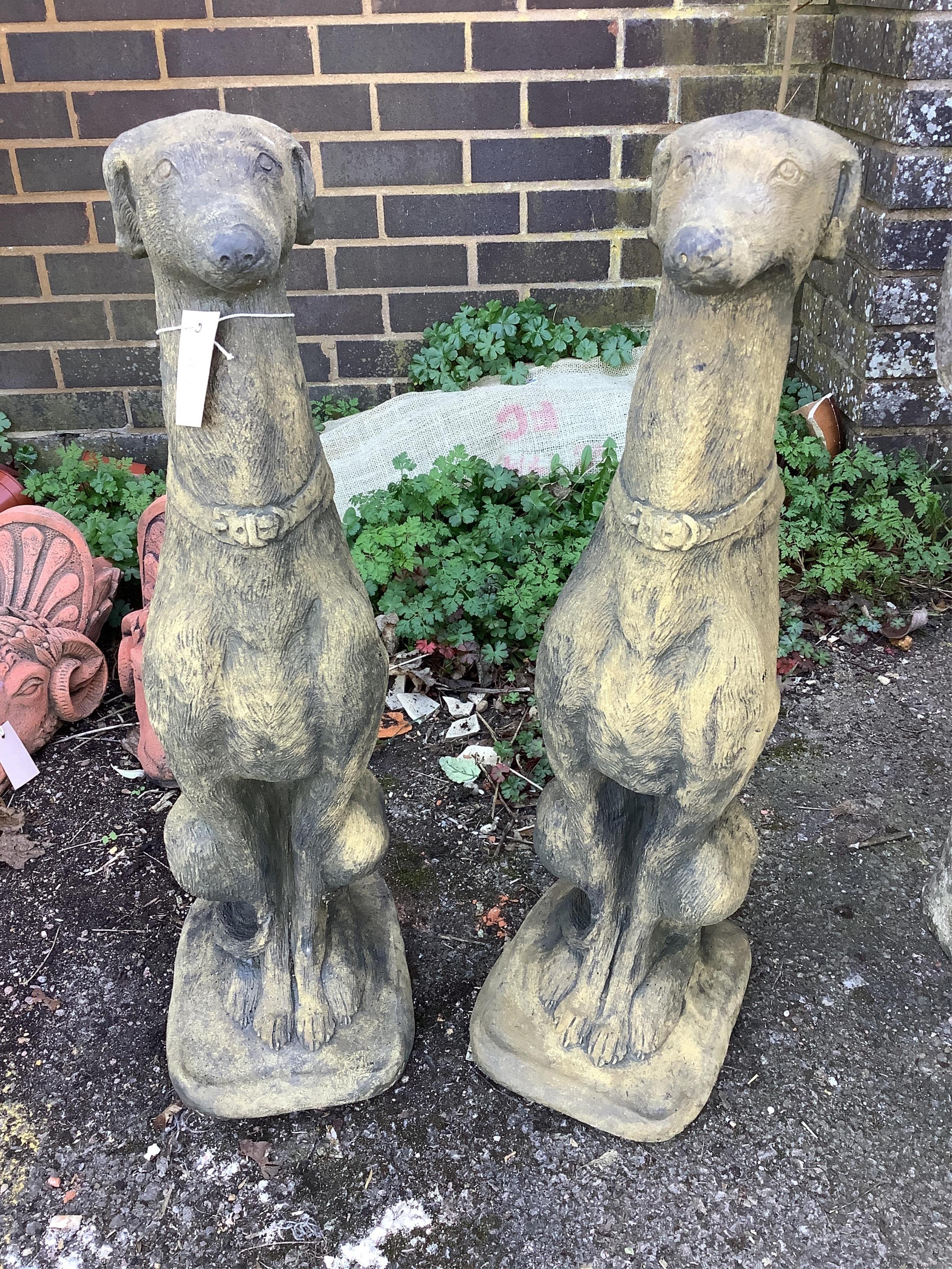 A pair of cast seated greyhound garden ornaments, height 74cm. Condition - good